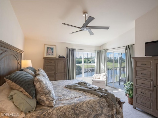 carpeted bedroom with vaulted ceiling, access to outside, and ceiling fan