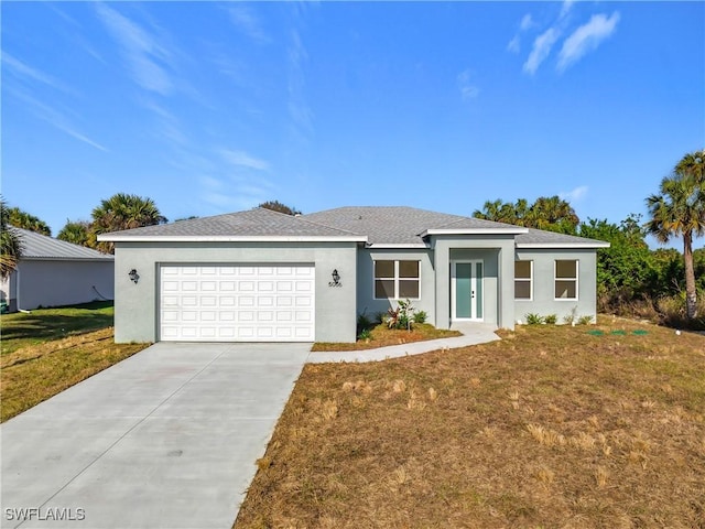 view of front of house featuring a garage and a front lawn