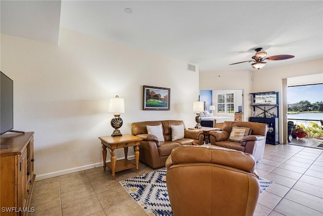 tiled living room with ceiling fan