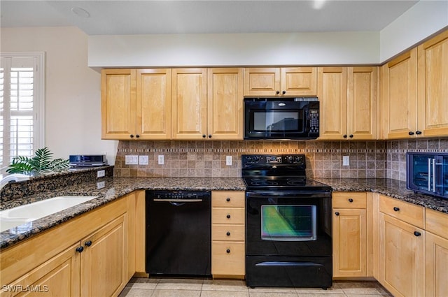 kitchen with tasteful backsplash, light brown cabinets, dark stone counters, and black appliances