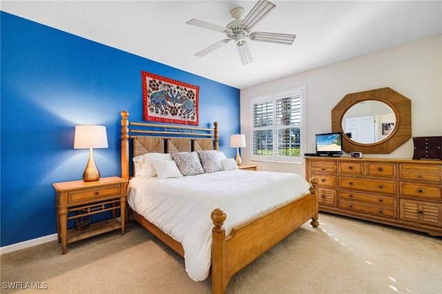 bedroom with light carpet and ceiling fan