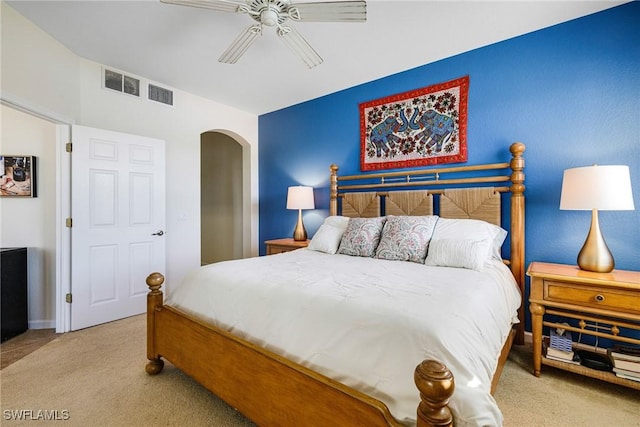 bedroom with ceiling fan and light carpet