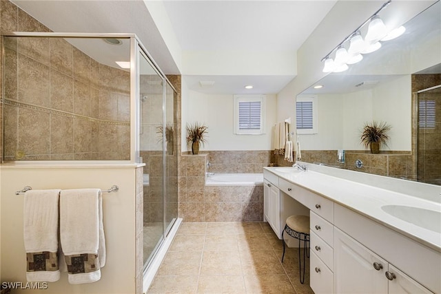 bathroom featuring vanity, shower with separate bathtub, and tile patterned floors