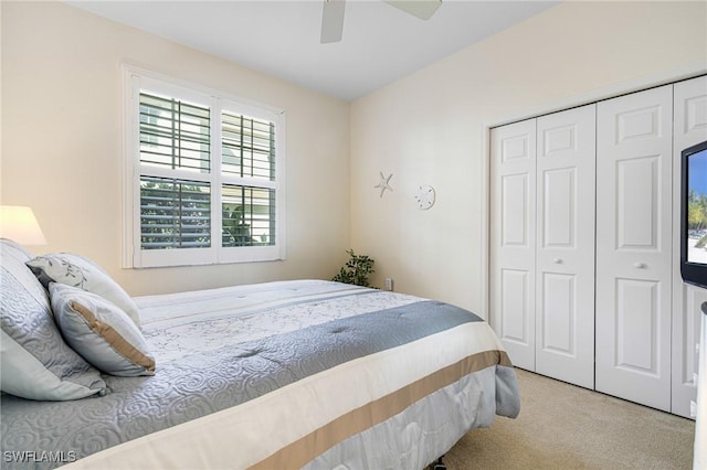 carpeted bedroom featuring a closet and ceiling fan