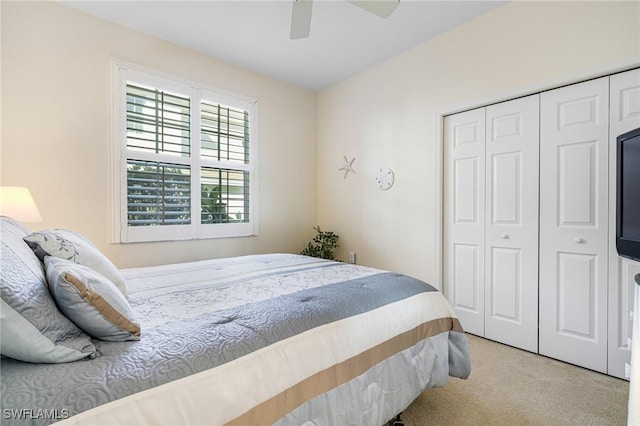 bedroom with light colored carpet, a closet, and ceiling fan