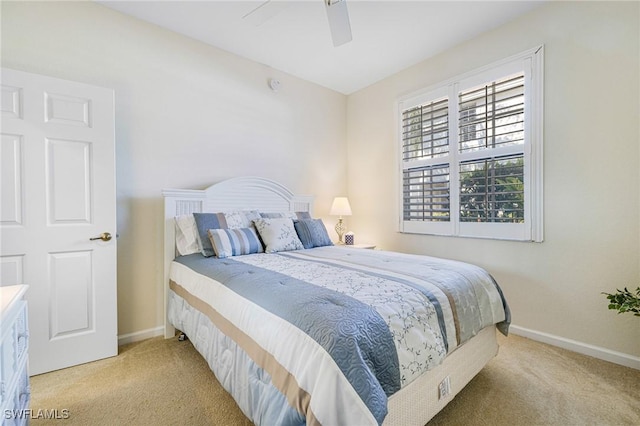 bedroom featuring light colored carpet and ceiling fan