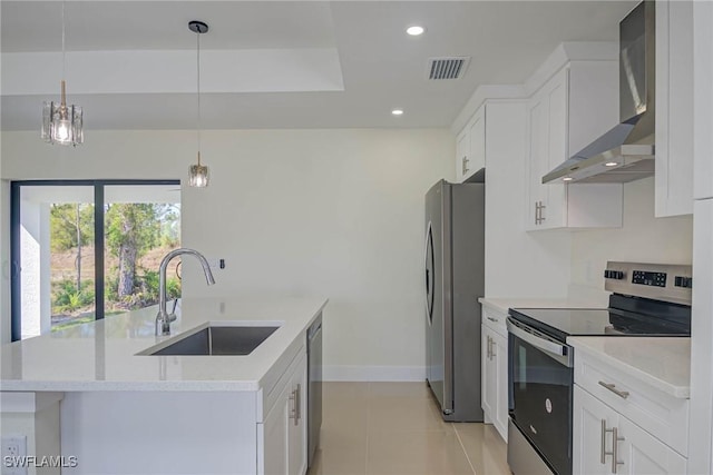 kitchen featuring wall chimney exhaust hood, white cabinetry, stainless steel appliances, and a sink