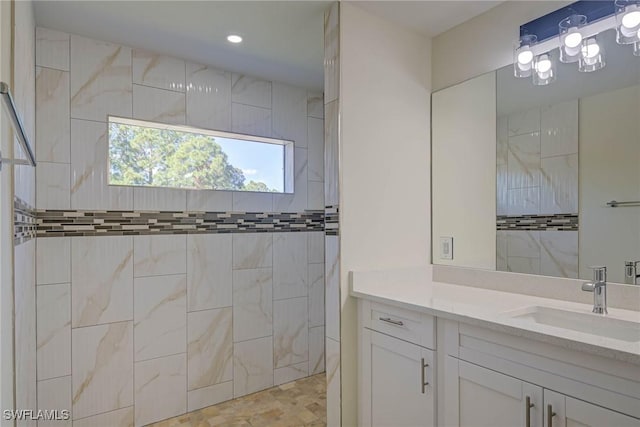 full bath featuring a walk in shower and vanity