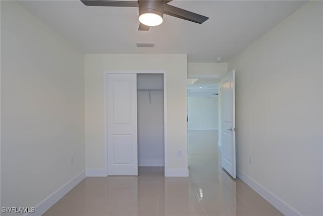 unfurnished bedroom with a closet, visible vents, baseboards, and light tile patterned floors