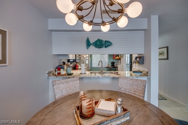 dining area featuring baseboards and a chandelier