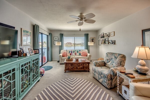 carpeted living room featuring ceiling fan