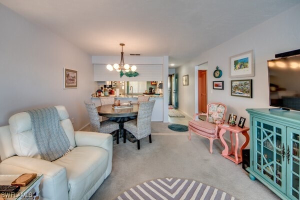 dining room with light carpet, an inviting chandelier, and visible vents