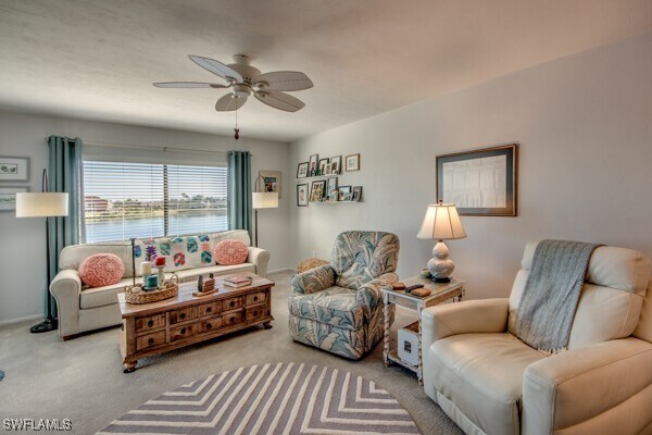 living room with ceiling fan and carpet flooring