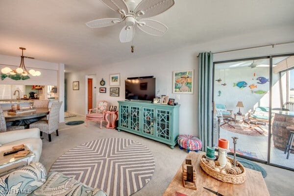 interior space with ceiling fan with notable chandelier