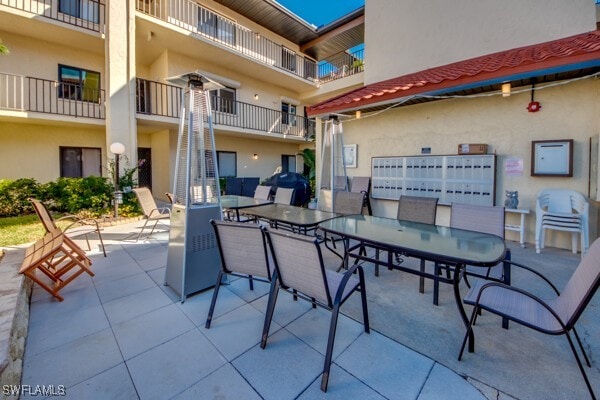 view of patio / terrace featuring stairs, outdoor dining space, and a grill