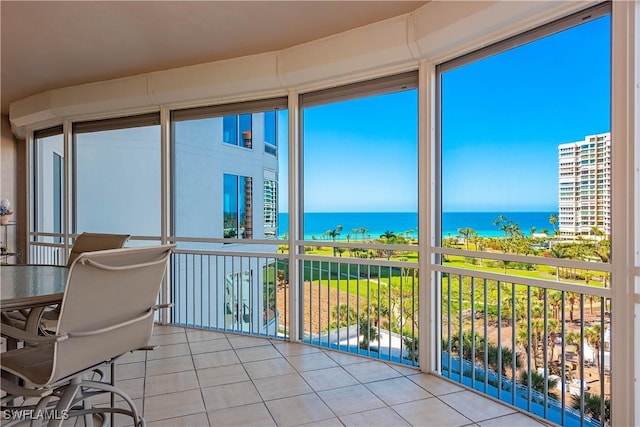 sunroom / solarium featuring a water view