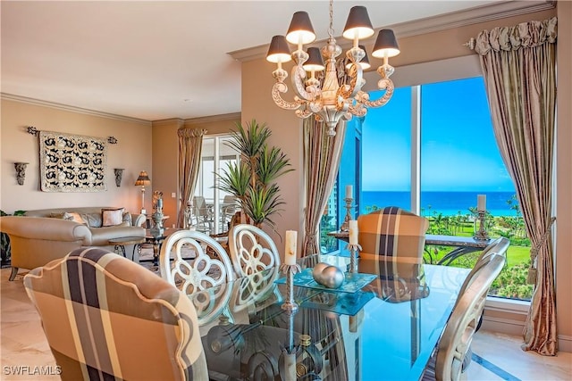 dining space with crown molding, a water view, and a chandelier