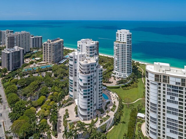 aerial view with a water view and a beach view