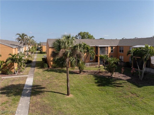 12658 Kenwood Ln Unit D, Fort Myers, FL 33907 - view of front facade featuring a front lawn and stucco siding