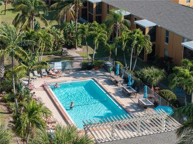 12658 Kenwood Ln Unit D, Fort Myers, FL 33907 - community pool with a patio and a gate