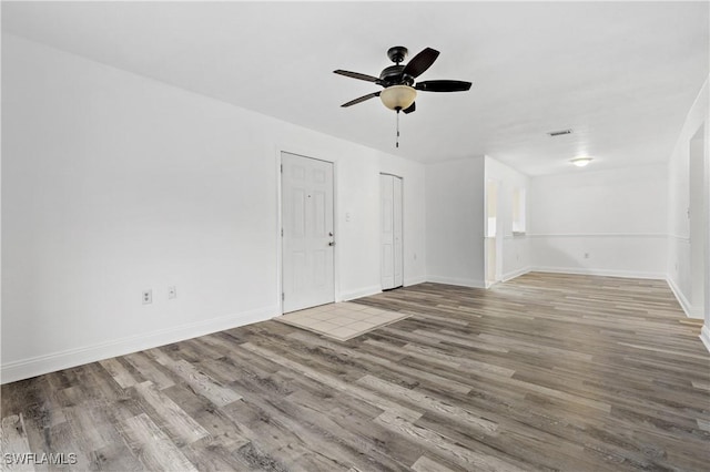 unfurnished living room with ceiling fan and light hardwood / wood-style flooring