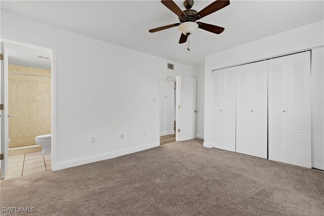 12658 Kenwood Ln Unit D, Fort Myers, FL 33907 - unfurnished bedroom with carpet flooring, ensuite bath, baseboards, a closet, and a ceiling fan