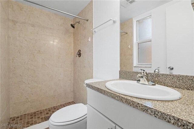 12658 Kenwood Ln Unit D, Fort Myers, FL 33907 - full bathroom with vanity, toilet, and a tile shower