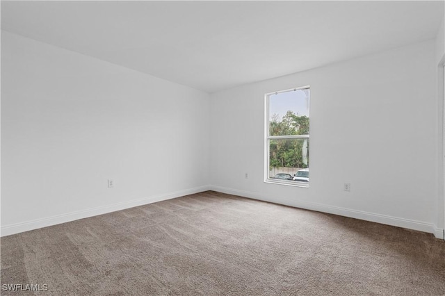 unfurnished room featuring carpet flooring