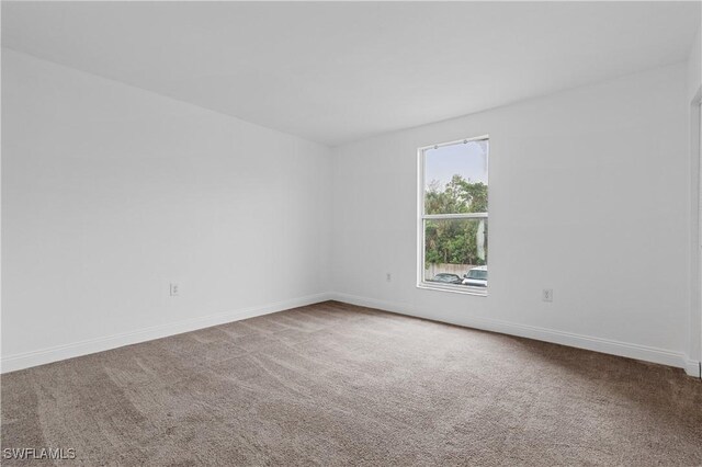 12658 Kenwood Ln Unit D, Fort Myers, FL 33907 - carpeted spare room with baseboards
