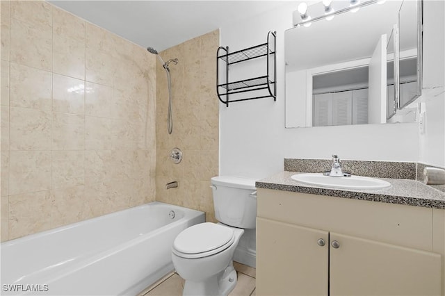 full bathroom featuring tiled shower / bath combo, vanity, tile patterned floors, and toilet