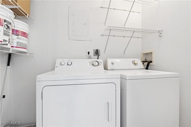 washroom featuring washing machine and clothes dryer and electric panel