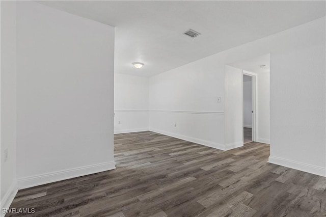 unfurnished room with dark hardwood / wood-style floors