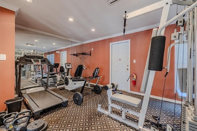 exercise room featuring crown molding and carpet floors