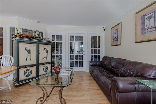 living room with crown molding and light wood-type flooring