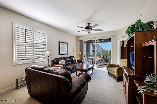 carpeted living room featuring ceiling fan