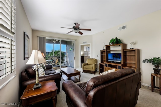 carpeted living room featuring ceiling fan