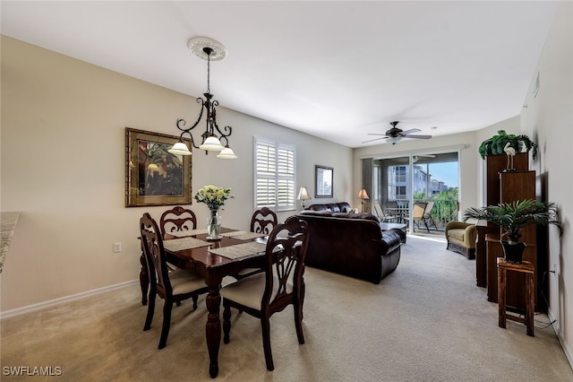 carpeted dining space with ceiling fan and plenty of natural light