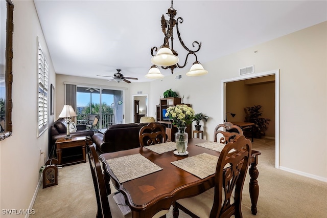 carpeted dining room with ceiling fan