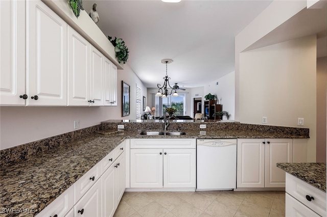 kitchen with white dishwasher, sink, hanging light fixtures, and white cabinets