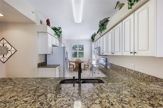 kitchen with stainless steel refrigerator with ice dispenser, white electric range oven, sink, white cabinetry, and dark stone counters