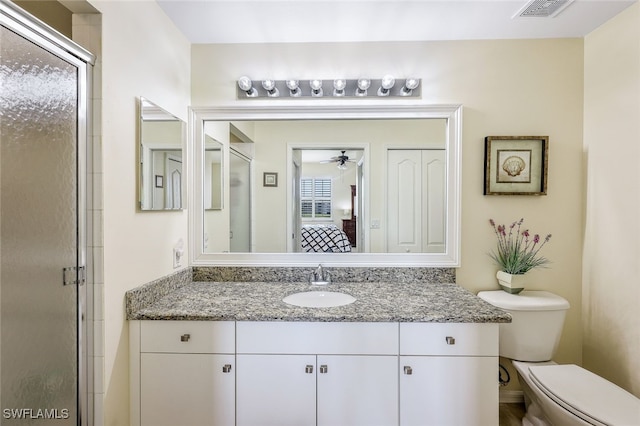 bathroom featuring vanity, toilet, and walk in shower