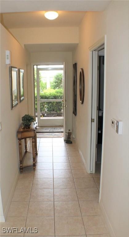 hall featuring light tile patterned floors