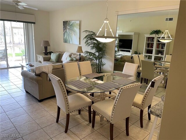 tiled dining space featuring ceiling fan