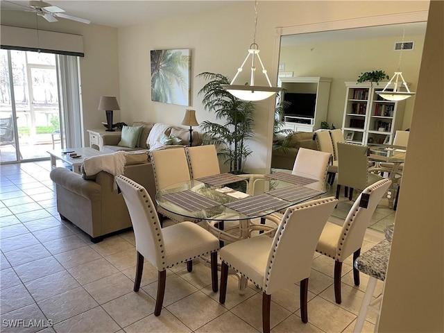 tiled dining room featuring ceiling fan