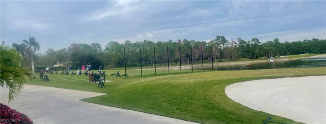 view of community featuring a water view and a lawn