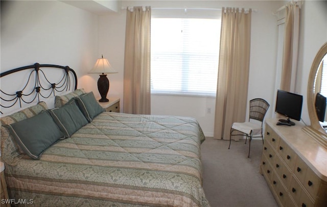 bedroom featuring light carpet