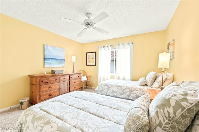 bedroom featuring carpet flooring, a textured ceiling, and ceiling fan