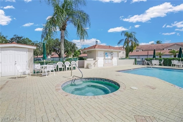 view of pool with a patio and a community hot tub