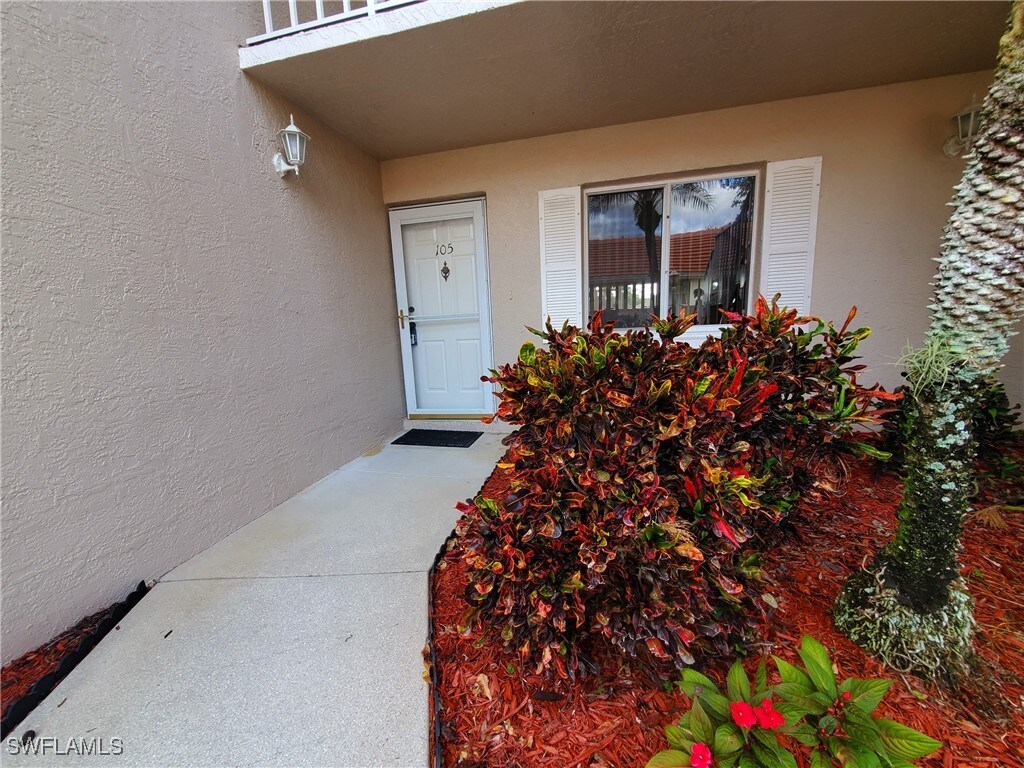 7185 Dennis Cir Unit C-105, Naples, FL 34104 - entrance to property featuring stucco siding