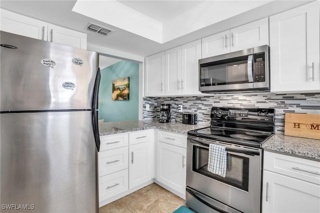 kitchen featuring stainless steel appliances and white cabinetry